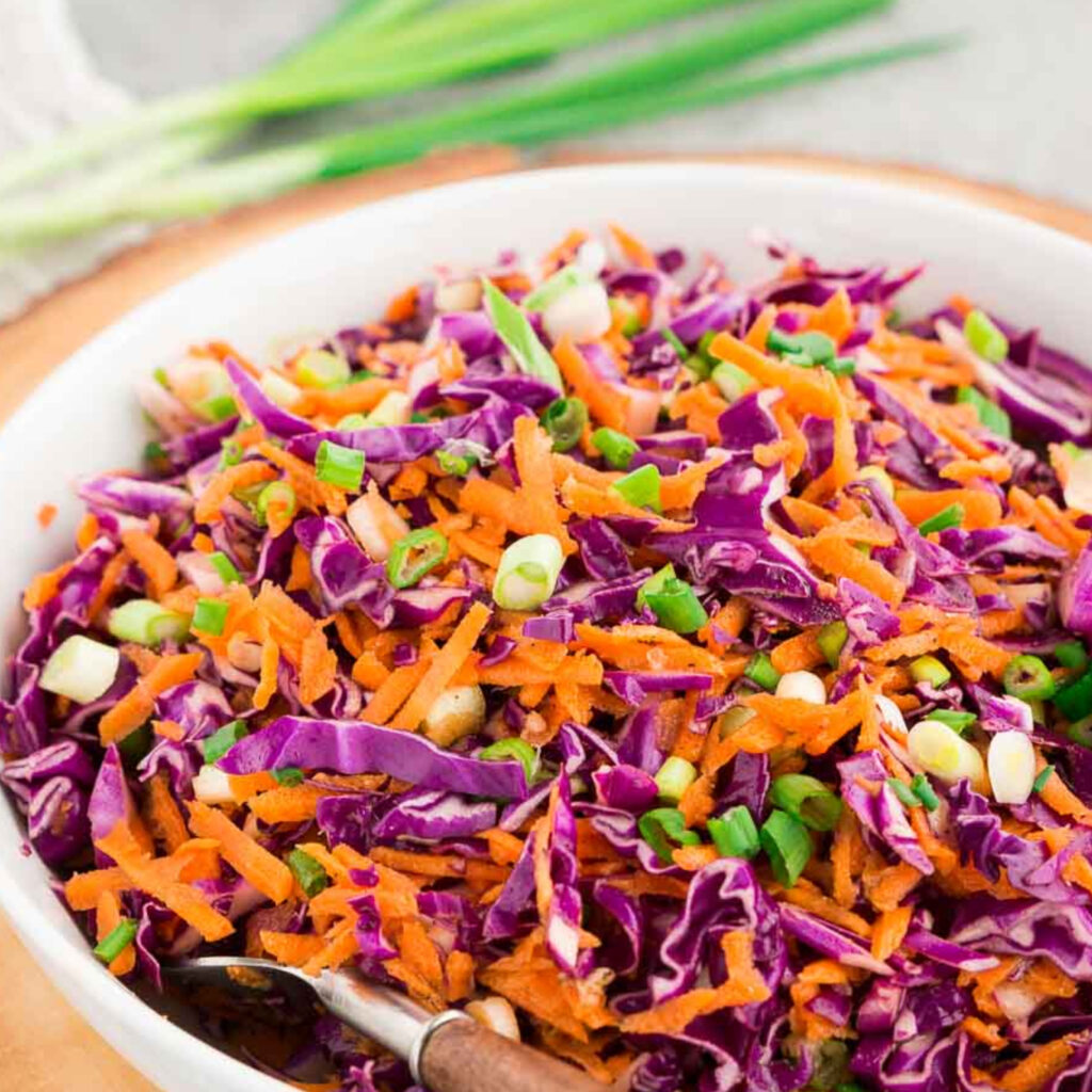 Red Cabbage Slaw with Honey Mustard Dressing image to showcase the beauty and yumminess of the recipe beautiful vibrant colors