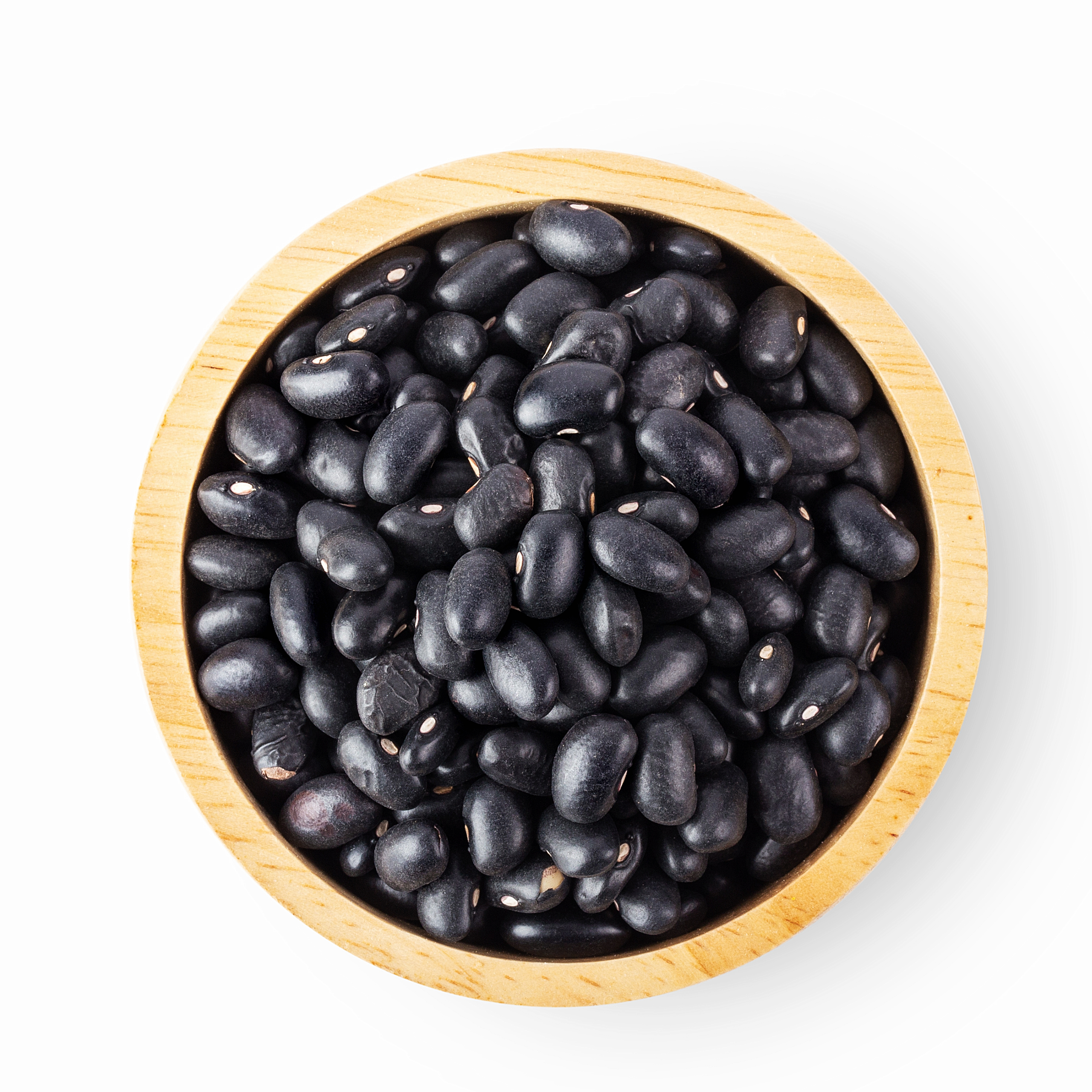 A wooden bowl filled with black beans, against a white background.